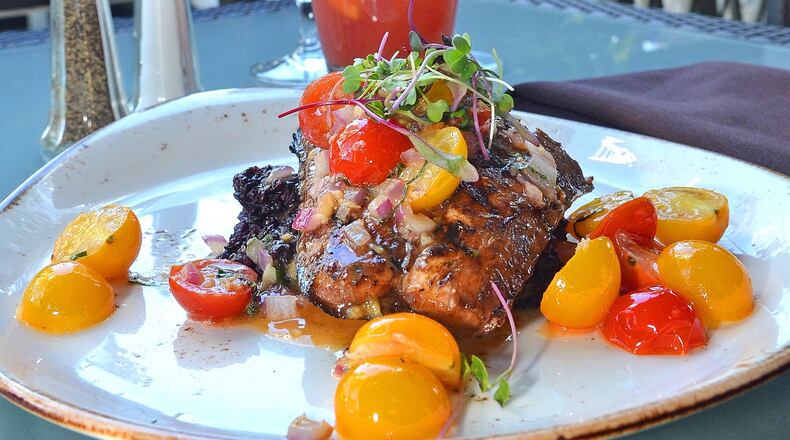 Grilled cobia with black rice and sauteed tomatoes. Styling by Tonya Morris / Contributed by Chris Hunt