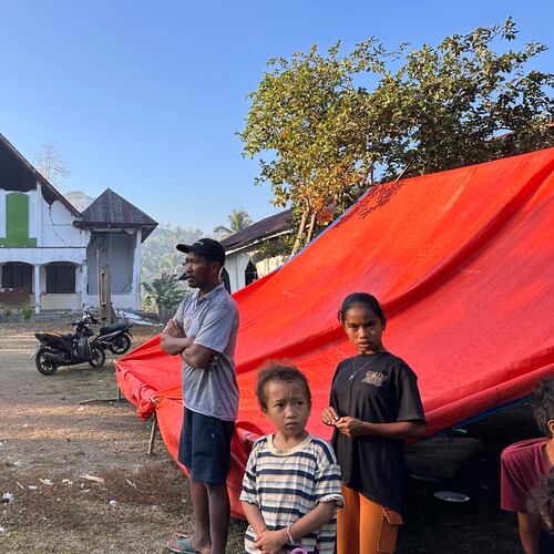 Earthquake survivors stand outside their tent erected near a damaged church in Satar Punda, East Nusa Tenggara province, Indonesia, Tuesday, Aug. 18, 2026. (AP Photo/Firdia Lisnawati)