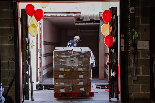 A Hosea Helps volunteer loads a shipment of donated turkeys for The Great Turkey Drop onto a truck Friday, Nov. 7, 2025. At one of the nonprofit’s food distributions last week, the need was overwhelming as Thanksgiving approaches. (Natrice Miller/AJC)