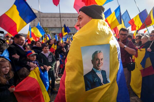 FILE - Supporters wait for Calin Georgescu, the winner of Romania's first round of presidential election, which the Constitutional Court later annulled, in Bucharest, Jan. 24, 2025. (AP Photo/Vadim Ghirda, File)