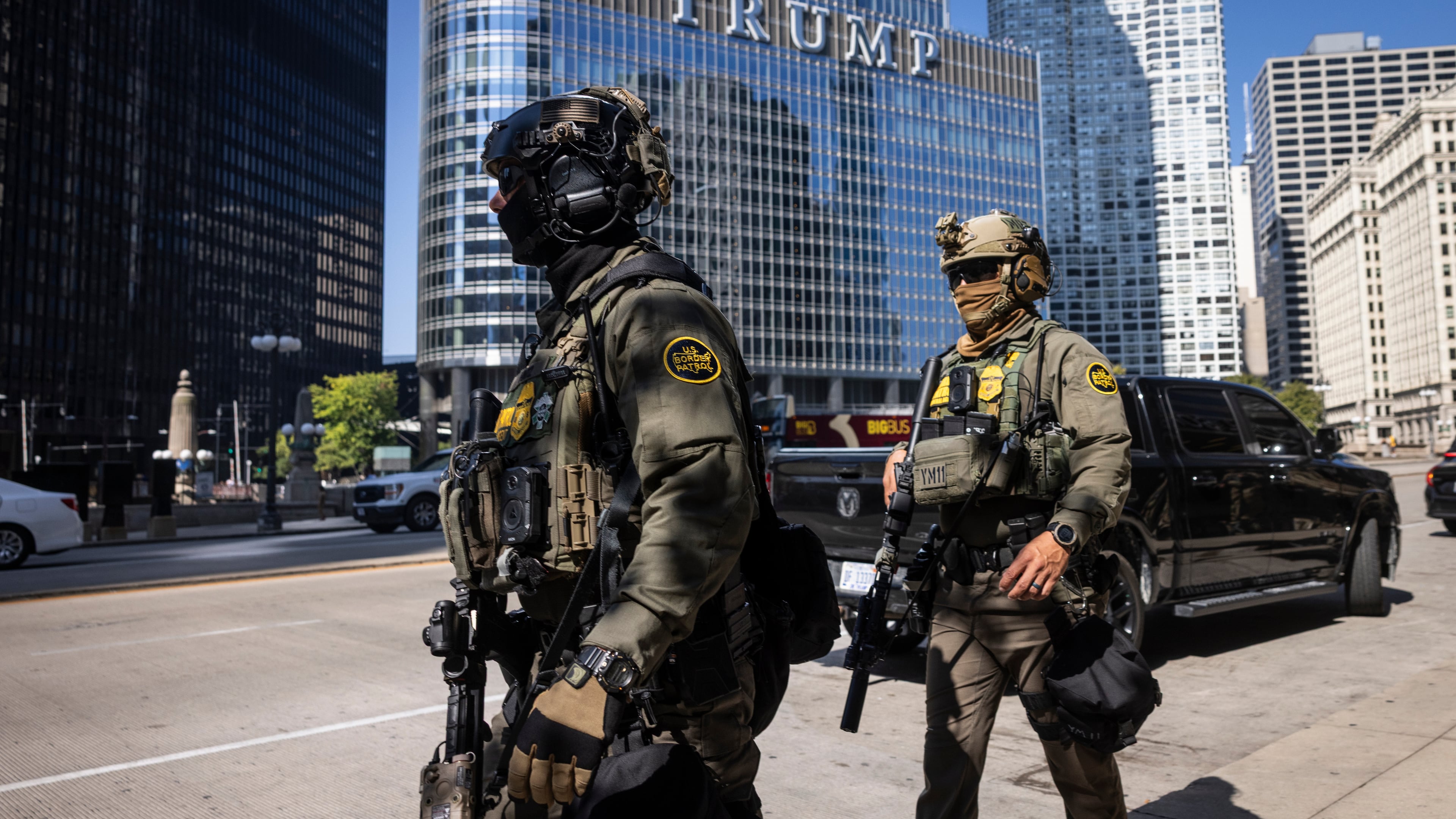 Federal agents from U.S. Immigration and Customs Enforcement and U.S. Customs and Border Protection walk along West Wacker Drive in the Loop, Sunday, Sept. 28, 2025, in Chicago. (Ashlee Rezin/Chicago Sun-Times via AP)