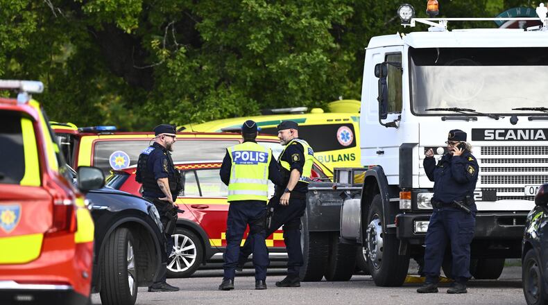 Police and emergency personnel outside Brinellskolan during a major emergency response after a man with a sword reportedly injured several people at the school in Fagersta, Sweden, Friday, Aug. 21, 2026. (Fredrik Sandberg/TT News Agency via AP)