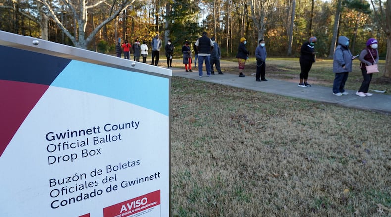 Voters stand in line to cast their ballots during the first day of early voting in the U.S. Senate runoffs at Lenora Park, December 14, 2020, in Atlanta. (Tami Chappell/AFP/Getty Images/TNS)