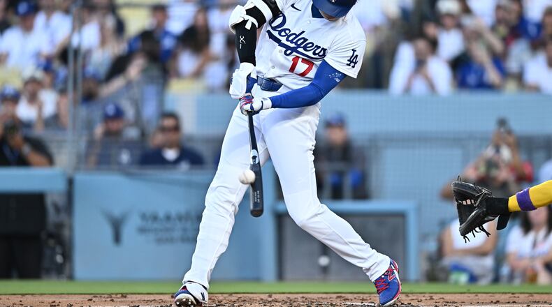 Los Angeles Dodgers' Shohei Ohtani hits a home run during the first inning of a baseball game against the Arizona Diamondbacks, Friday, July 10, 2026, in Los Angeles. (AP Photo/William Liang)