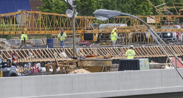 Since a fire led to the collapse of a segment of I-85 in Buckhead March 30, the Georgia Department of Transportation has scrambled to reopen the vital stretch of highway into the heart of Atlanta. Officials now say the collapsed bridge will open May 26, ahead of the previous June date. JOHN SPINK / JSPINK@AJC.COM
