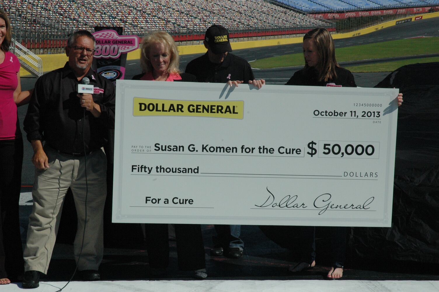 IMAGES: NASCAR drivers, breast cancer survivors paint pit road pink