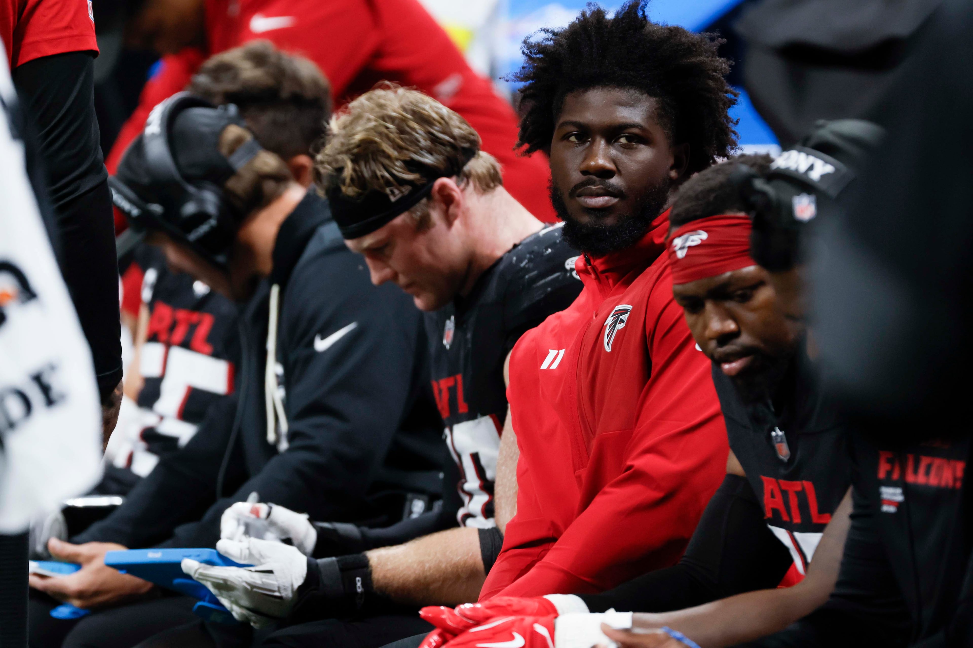 Atlanta Falcons defensive end Jalon Walker (second from right) is seen on the sidelines as he is not playing due to an injury during the second half of an NFL football game against the Miami Dolphins at Mercedes-Benz Stadium in Atlanta on Sunday, Oct. 26, 2025. (Miguel Martinez/AJC)