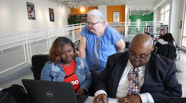 Student Destiny Glass, 18, works with special education teacher Ladonna Crowder (standing) during her study time at the Graduation Achievement Charter High School learning center Tuesday, April 22, 2018, in Atlanta.  PHOTO / JASON GETZ