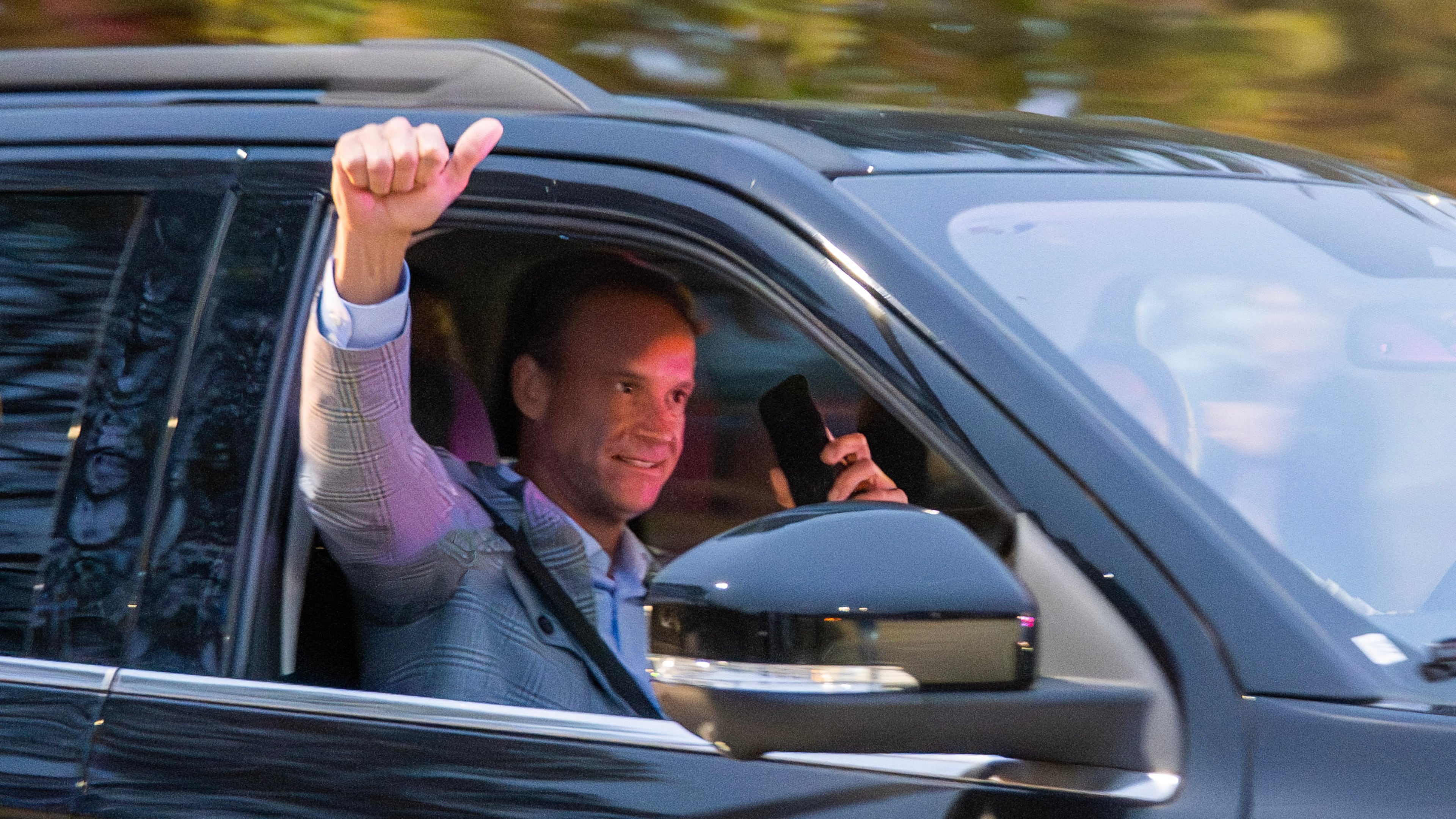 New LSU football coach Lane Kiffin pumps his fist to the crowd while leaving the MMR hanger on Sunday, Nov. 30, 2025 in Baton Rouge, La. (Michael Johnson/The Advocate via AP)