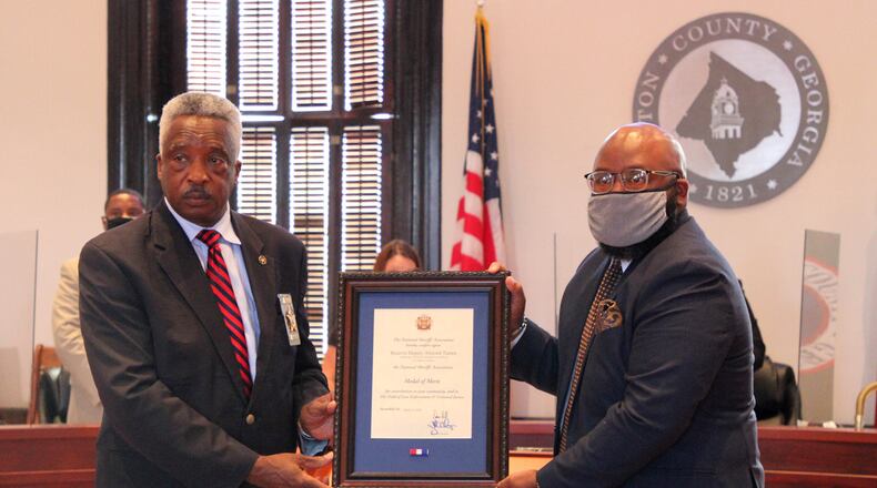 On behalf of the National Sheriffs’ Association,
Sheriff Ezell Brown presented the son of the late Deputy Almond Turner,
Dwahn Turner, with a Certificate of Merit from the National Sheriffs’
Association on Tuesday, Aug. 18, during the Newton County Board of
Commissioners meeting. Sheriff Brown and the Newton County Sheriff’s Office nominated Deputy Turner - on his behalf - for the 2020 National Sheriffs' Association “Reserve Deputy of the Year Award,” a title he held prior to his
unexpected death on Nov. 23, 2019.