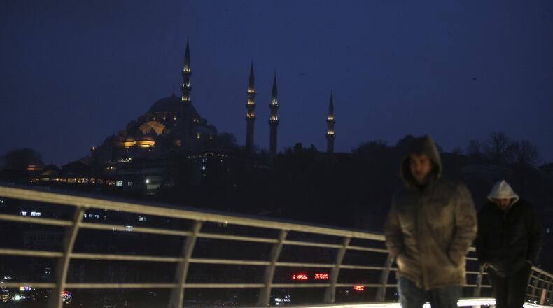 People walk over the Golden Horn Bridge in Istanbul, Friday, Jan. 6, 2017. Turkey's economy is suffering in the face of a string of extremist attacks -- including the nightclub massacre of New Year's revelers, most of them foreigners -- and uncertainty following the failed coup in July against President Recep Tayyip Erdogan that saw more than 270 people killed. AP Photo/ Emrah Gurel)