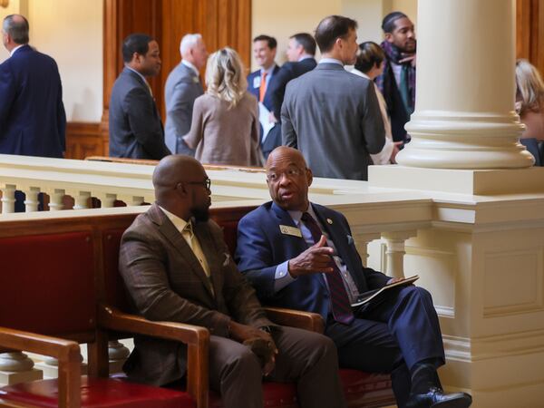 State Rep. Karlton Howard, D-Augusta (right) is pictured talking with a man at the Capitol in Atlanta last year. (Jason Getz/AJC)