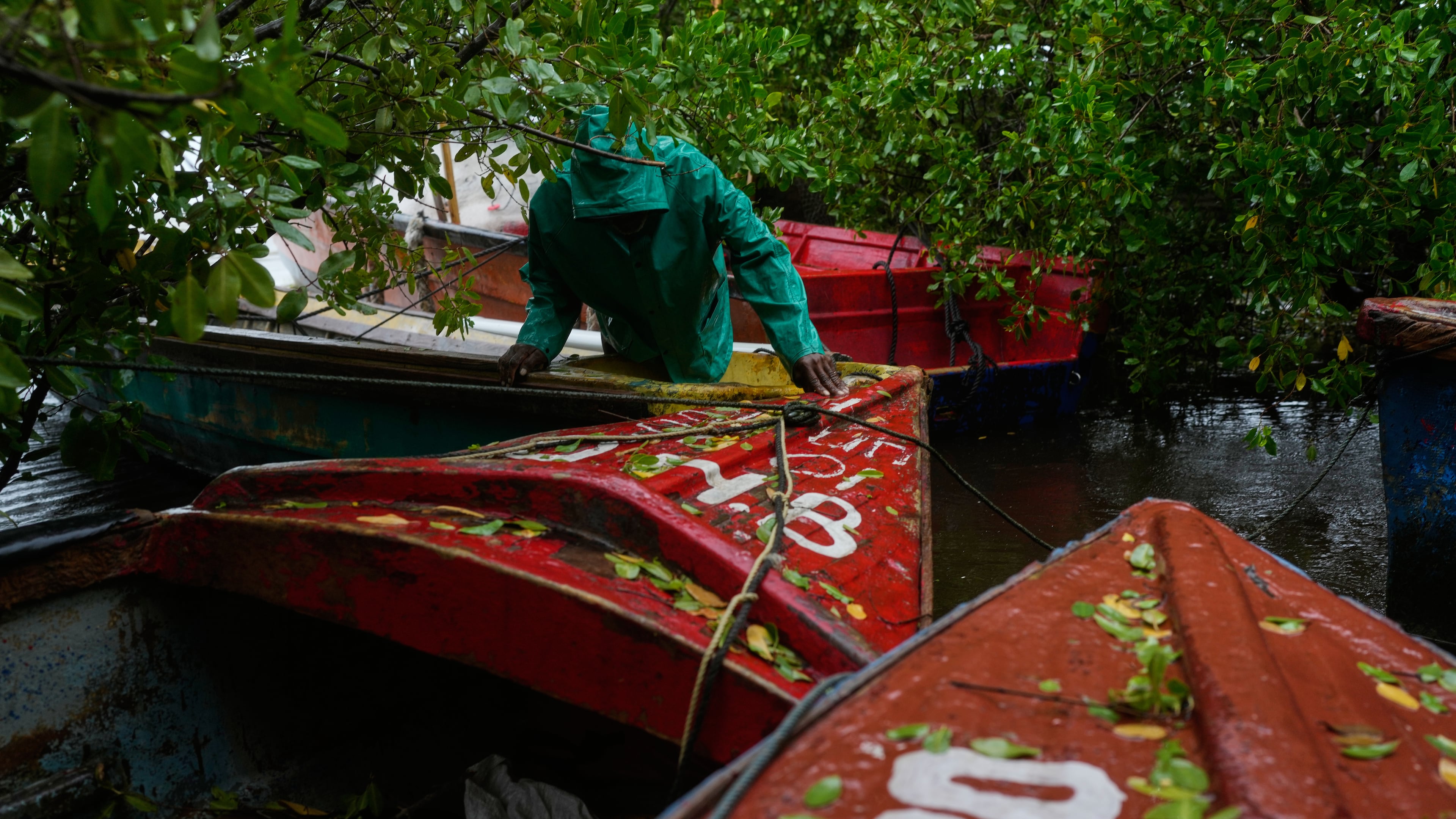 A fisherman ties boats in preparation for the forecasted arrival of Hurricane Melissa in Old Harbour, Jamaica, Monday, Oct. 27, 2025. (AP Photo/Matias Delacroix)