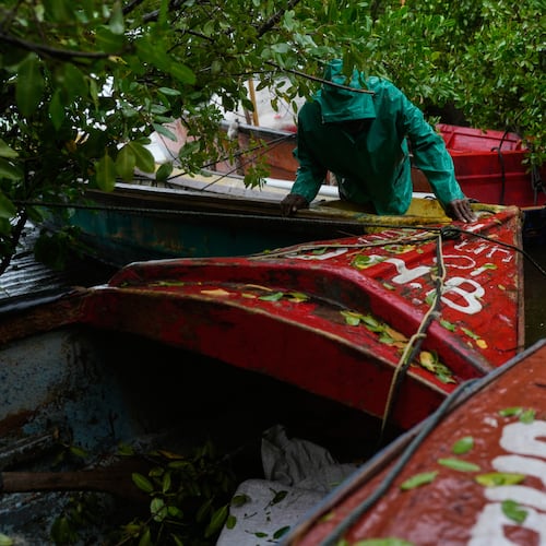 A fisherman ties boats in preparation for the forecasted arrival of Hurricane Melissa in Old Harbour, Jamaica, Monday, Oct. 27, 2025. (AP Photo/Matias Delacroix)
