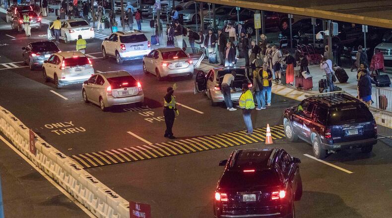 Uber and Lyft drivers pick up passengers at the Rideshare location at Hartsfield-Jackson International Airport, Thursday, Nov. 9, 2017, in Atlanta. BRANDEN CAMP/SPECIAL