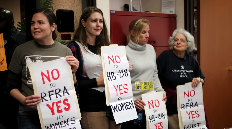 Emma Stitt, from left, Megan Harrison, Jessica Reznicek and Lorraine Fontana stand in Sen. Josh McKoon's, R-Columbus, office in the Coverdell Legislative Office Building in protest of the "religious liberty" bill that McKoon is sponsoring. The four were arrested after they were asked to wait in the hallway, but they refused to leave. The protest was part of Moral Monday Georgia. Ben Gray / bgray@ajc.com