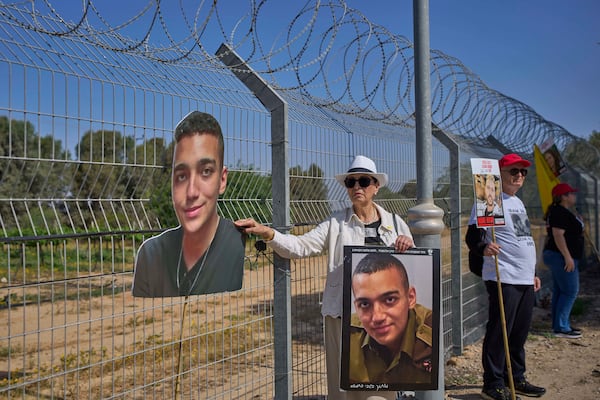 FILE - Varda Ben Baruch, holds a picture of her grandson Edan Alexander who is held hostage in Gaza, near the Gaza border in Kibbutz Nir Oz, southern Israel, on April 20, 2025. (AP Photo/Ohad Zwigenberg, File)