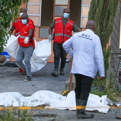 Red Cross members recover the bodies of students who died in the fire at the Utumishi Girls School in the Gilgil area, central Kenya, Thursday, May 28, 2026. (AP Photo/Andrew Kasuku)