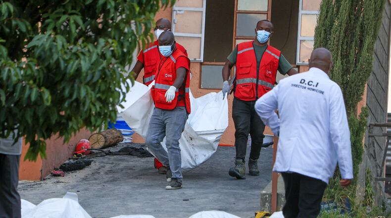 Red Cross members recover the bodies of students who died in the fire at the Utumishi Girls School in the Gilgil area, central Kenya, Thursday, May 28, 2026. (AP Photo/Andrew Kasuku)