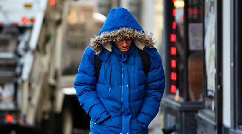 A pedestrian walks up the sidewalk on Hurt Plaza SE in downtown Atlanta in sub-freezing temperatures Tuesday. This weekend is expected to be just as cold, with a chance of snow, in metro Atlanta. (Ben Hendren for the AJC)