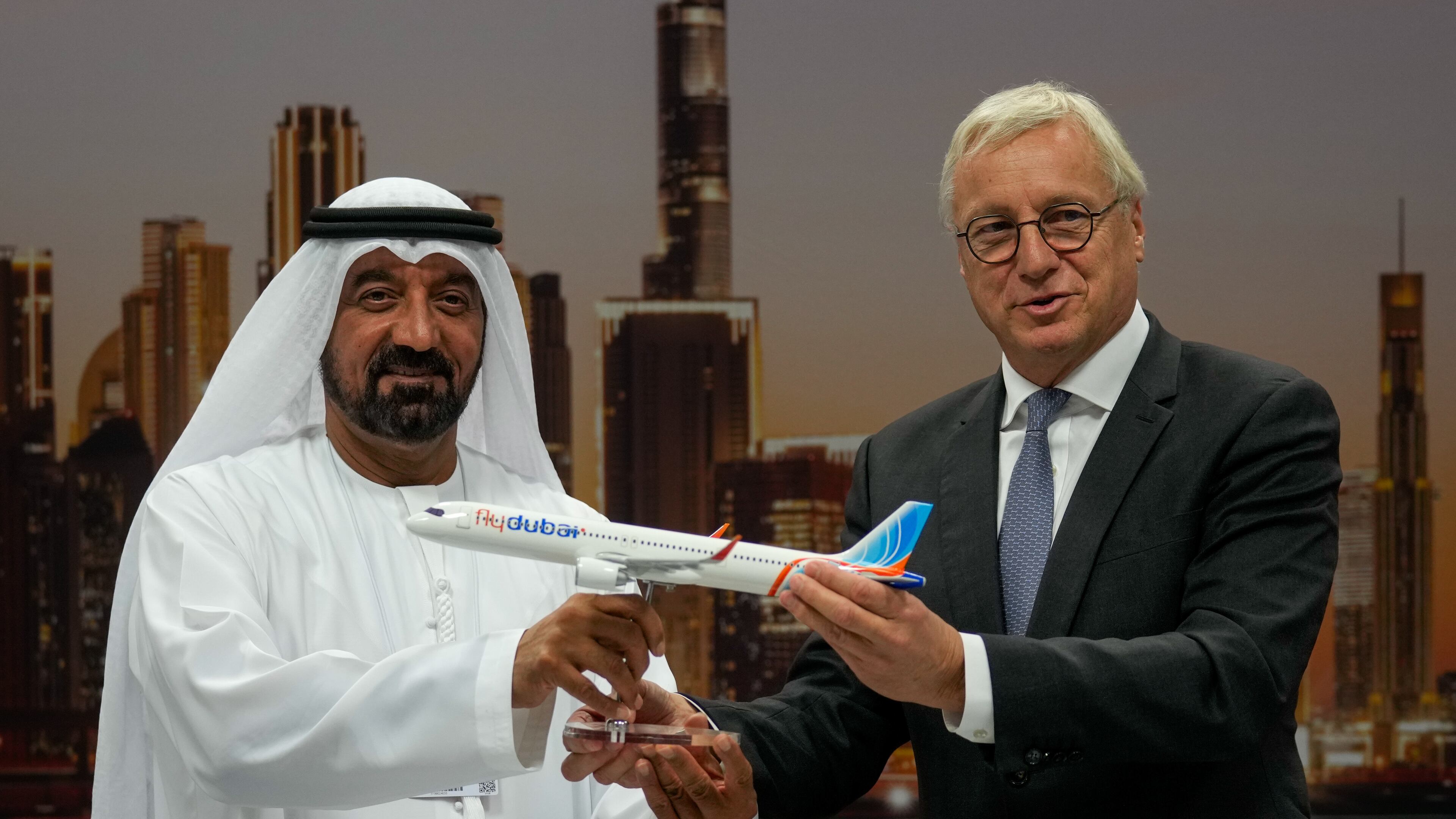 Airbus' CEO of commercial aircraft Christian Scherer presents a model of Airbus A321neo aircraft to Sheikh Ahmed bin Saeed Al Maktoum, the chairman and chief executive of Emirates and chairman of FlyDubai at a press conference to announce an order for 150 Airbus A321neo aircraft at the Dubai Air Show, United Arab Emirates, Tuesday, Nov. 18, 2025. (AP Photo/Altaf Qadri)