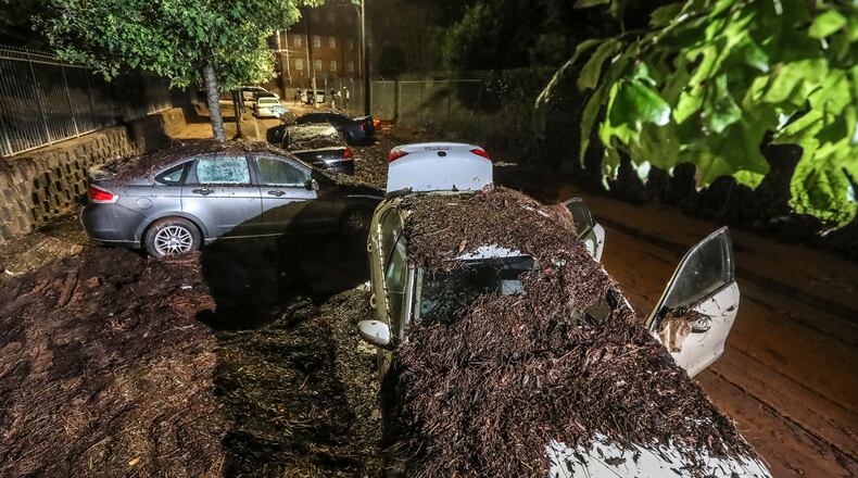 Along Parsons Street near Lawshe Street through Clark Atlanta University, so much mud was left behind that it looked like a dirt road as flooded cars remained after the water receded Friday morning, Sept. 15, 2023. (John Spink/The Atlanta Journal-Constitution/TNS)