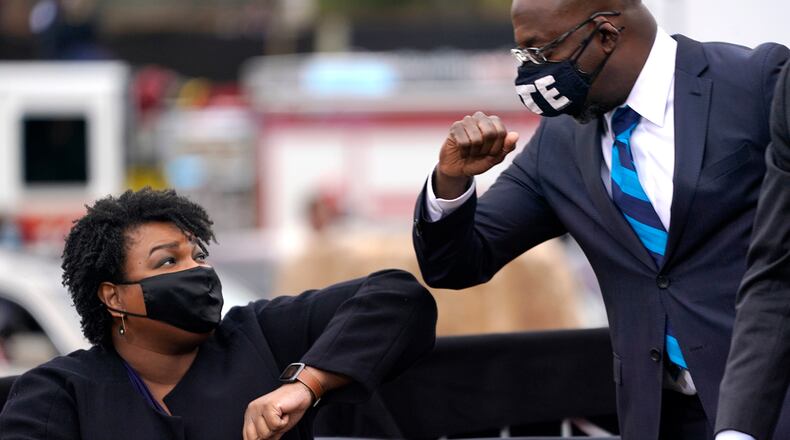 Democratic U.S. Sen. Raphael Warnock and Georgia Democratic gubernatorial candidate Stacey Abrams have both pledged to protect abortion rights as part of their campaigns. Abrams, however, would limit the right to the procedure "until a physician determines the fetus is viable outside of the body." Warnock has not indicated support for any limits. (Drew Angerer/Getty Images/TNS)