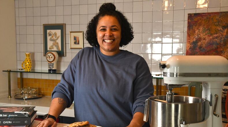 Tiny Lou's executive pastry chef Charmain Ware-Jason poses with her inspirational cookbooks, trusted KitchenAid mixer and a plate of her chocolate chip cookies. (CHRIS HUNT FOR THE ATLANTA JOURNAL-CONSTITUTION)