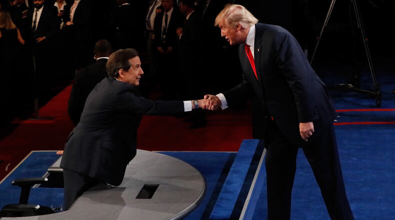 Republican presidential nominee Donald Trump shakes hands with Fox News anchor and moderator Chris Wallace after the third U.S. presidential debate in Las Vegas last week. Mark Ralston-Pool/Getty Images