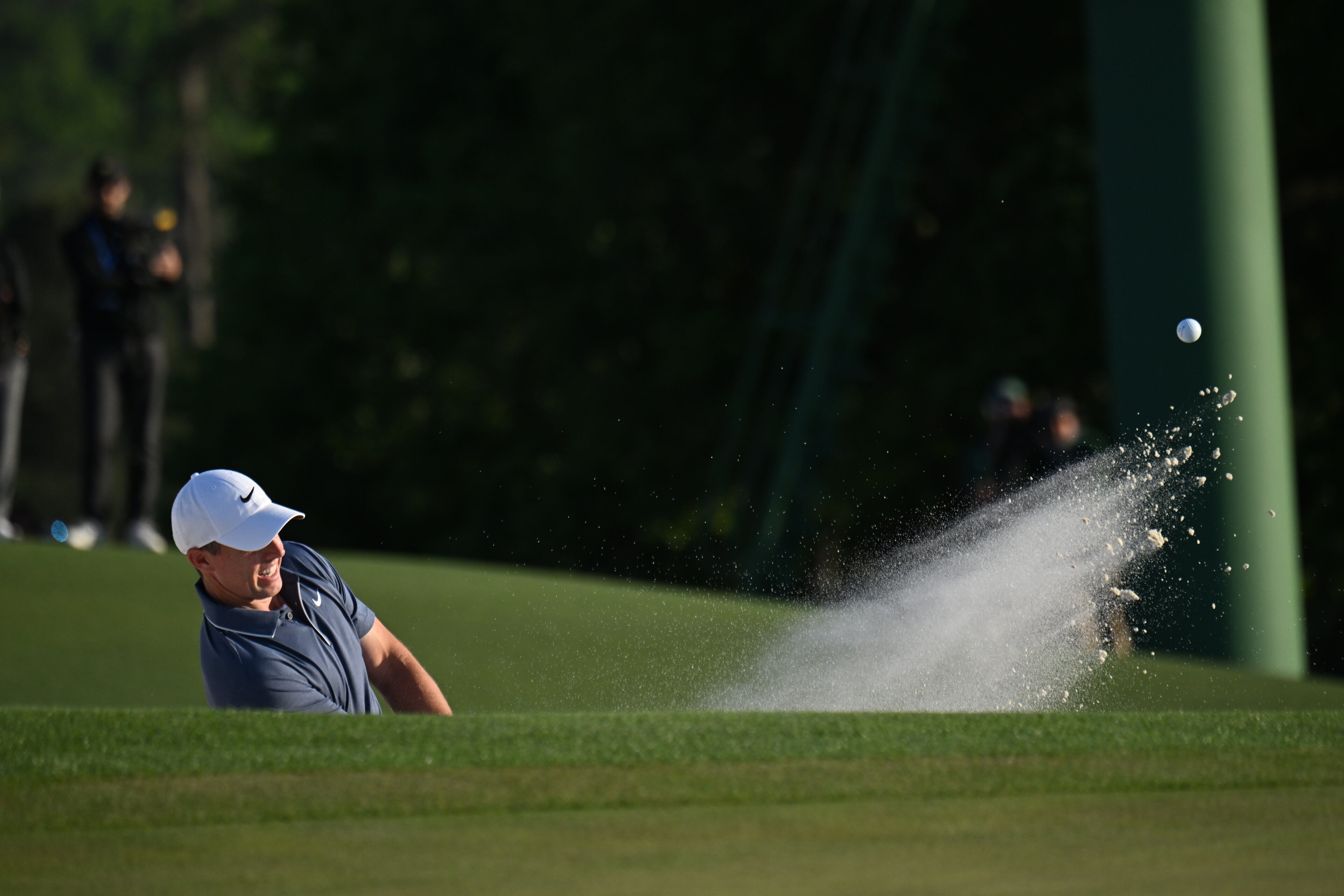 Rory McIlroy hits out of bunker of 18th hole during final round of the Masters golf tournament, at Augusta National Golf Club, Sunday, April 13, 2025, in Augusta, Ga. (Hyosub Shin / AJC)