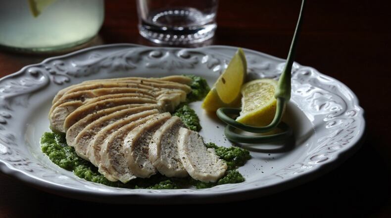 Garlic scapes, the stalks of a garlic plant, make a powerful pesto that serves as a bed for gently dry-poached chicken. Joan Moravek / food styling  (Abel Uribe/Chicago Tribune/TNS)