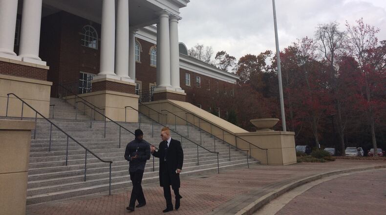 Black Lives Matter Great Atlanta activists walk in front of Roswell City Hall after a meeting.