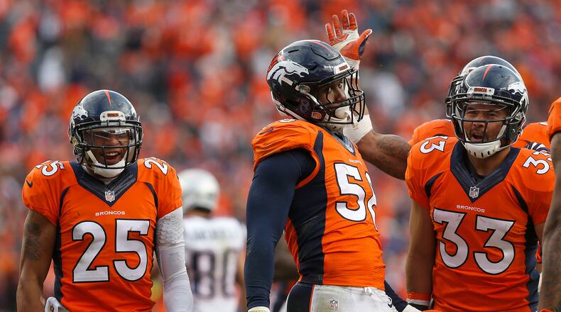 Denver Broncos outside linebacker Von Miller (58) is congratulated by his teammates after a play during the second half of the NFL football AFC Championship game between the Denver Broncos and the New England Patriots, Sunday, Jan. 24, 2016, in Denver. (AP Photo/David Zalubowski)