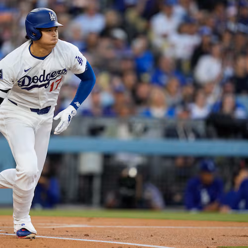 Los Angeles Dodgers' Shohei Ohtani heads to first for a single during the first inning of a baseball game against the Los Angeles Dodgers, Tuesday, May 12, 2026, in Los Angeles. (AP Photo/Mark J. Terrill)