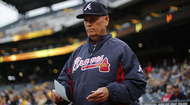 Brian Snitker looks over his lineup card as he heads to home plate to meet with the umpires before a game against the Pittsburgh Pirates in Pittsburgh in May. (AP photo)