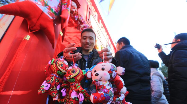 BEIJING, CHINA - FEBRUARY 08: (CHINA OUT) A man carries monkey toys during Ditan Temple (Temple of Earth Park) fair on first day of new Year of Monkey on February 8, 2016 in Beijing, China. Chinese people celebrate the Spring Festival for the new Year of Monkey, which fell on February 8 according to Chinese calendar. (Photo by ChinaFotoPress/ChinaFotoPress via Getty Images)