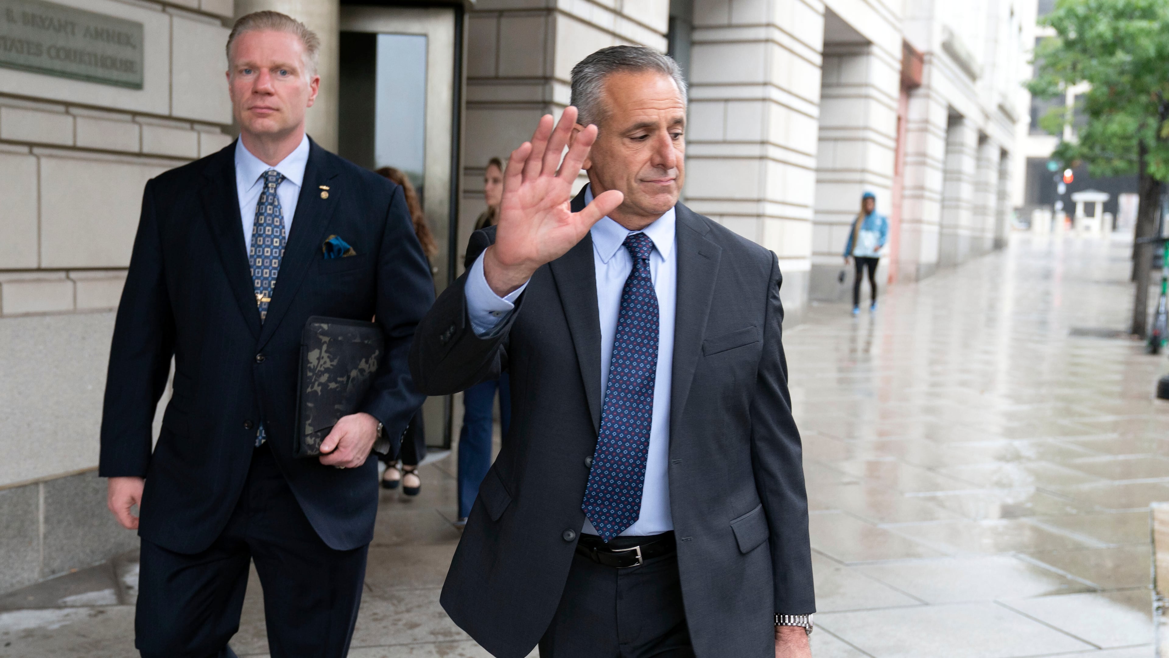 Retired Adm. Robert P. Burke, 63, right, walks out of the federal courthouse after being sentenced to six years in prison for his conviction on corruption charges, Tuesday, Sept. 16, 2025, in Washington. (AP Photo/Jose Luis Magana)
