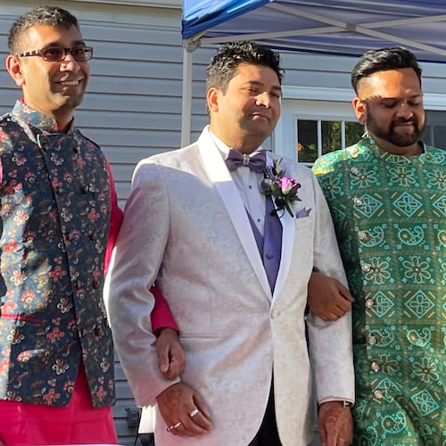 This photo provided by Jolene Gosha shows Venus Patel, left, walking his friend, Pratik Jhaveri, center, down the wedding aisle in Collinsville, Ill., June 18, 2022. CORRECTION: Corrects Jolene's surname from Gosh to Gosha. (Jolene Gosha via AP)