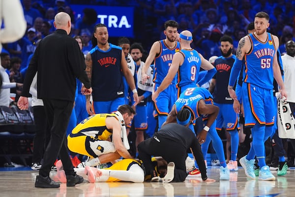 Indiana Pacers guard Tyrese Haliburton, center, lays on the court after an injury during the first half of Game 7 of the NBA Finals basketball series against the Oklahoma City Thunder Sunday, June 22, 2025, in Oklahoma City. (AP Photo/Julio Cortez)