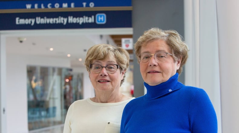 Identical twin sisters Fania Szlam (left) and Dora Richter were recently recognized by the Georgia Hospital Association for their longtime dedication and service to healthcare. They’ve both worked at Emory Healthcare/Emory University for more than 40 years, and have won many awards during this time. (Photo by Phil Skinner)