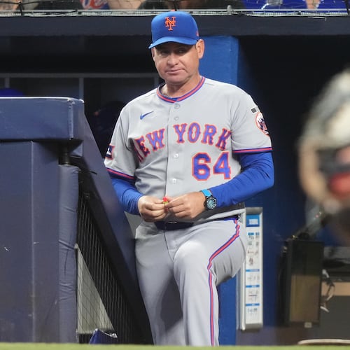 FILE - New York Mets manager Carlos Mendoza (64) watches during the first inning of a baseball game against the Miami Marlins, Saturday, May 23, 2026, in Miami. (AP Photo/Lynne Sladky, File)