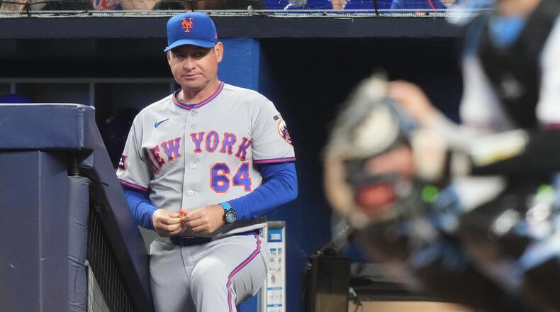 FILE - New York Mets manager Carlos Mendoza (64) watches during the first inning of a baseball game against the Miami Marlins, Saturday, May 23, 2026, in Miami. (AP Photo/Lynne Sladky, File)