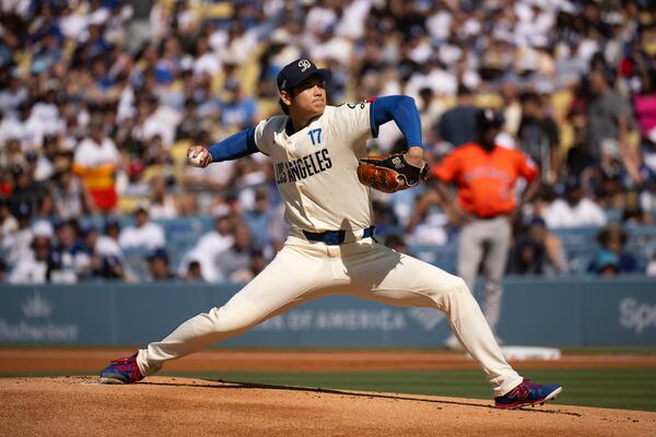 Los Angeles Dodgers starting pitcher Shohei Ohtani delivers during the first inning of a baseball game against the Houston Astros in Los Angeles, Saturday, July 5, 2025. (AP Photo/Kyusung Gong)