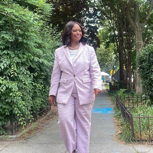 District of Columbia mayoral candidate Janeese Lewis George walks down a street while canvassing in a Washington, neighborhood, Monday, June 15, 2026. (AP Photo/Matt Brown)