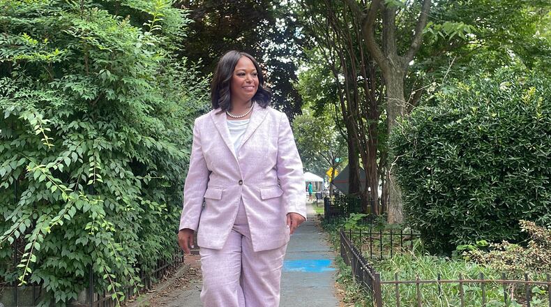 District of Columbia mayoral candidate Janeese Lewis George walks down a street while canvassing in a Washington, neighborhood, Monday, June 15, 2026. (AP Photo/Matt Brown)