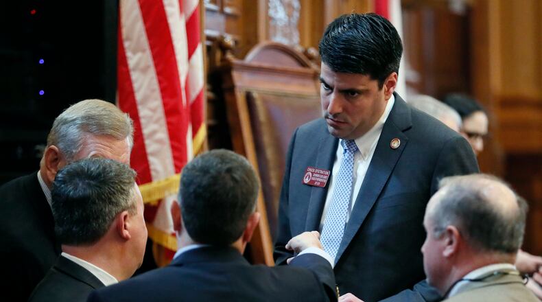 Atlanta - Rep. Chuck Efstration, R - Dacula,  one of Gov. Brian Kemp's floor leaders, huddles with colleagues on the House Floor earlier in the 2019 session. BOB ANDRES  /BANDRES@AJC.COM