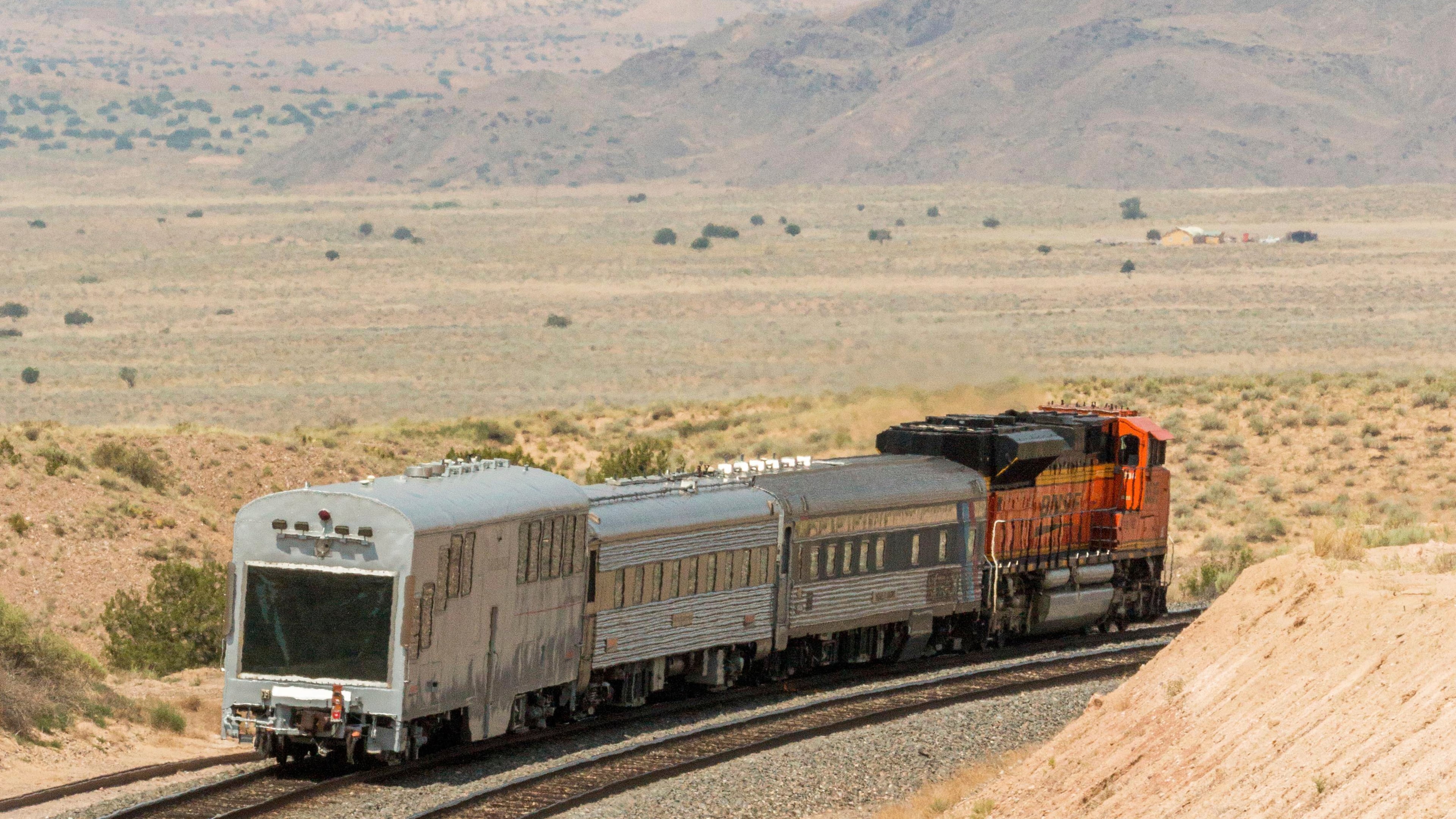 A BNSF locomotive pulls an automated track inspection railcar down the tracks in Valencia County, New Mexico, July 31, 2018. (BNSF Railway via AP)