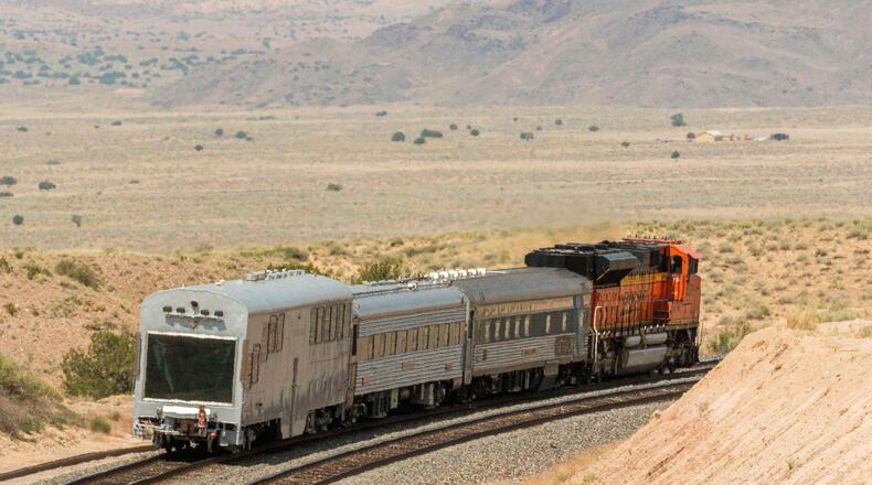 A BNSF locomotive pulls an automated track inspection railcar down the tracks in Valencia County, New Mexico, July 31, 2018. (BNSF Railway via AP)