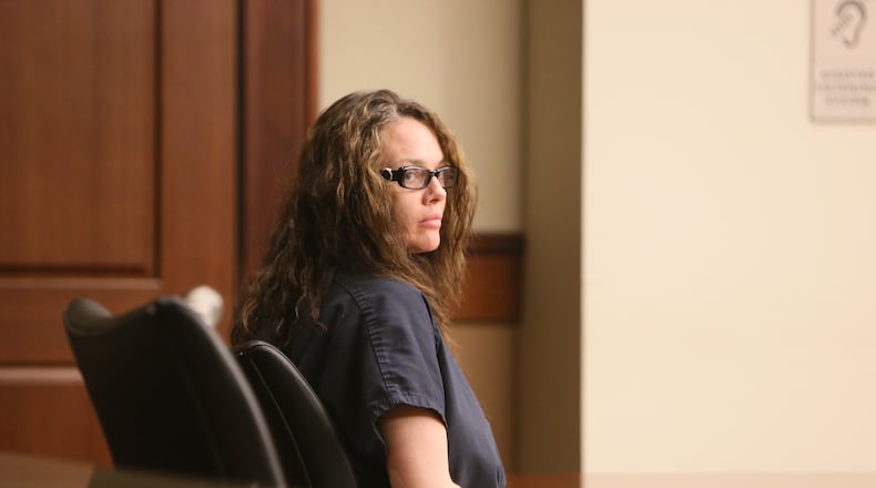 In a navy jail suit, Anna Benson, 37, sat quietly Thursday afternoon in Cobb County Superior Court as her attorney asked Judge LaTain Kell to grant $50,000 bond, along with numerous stipulations, including psychological evaluation and treatment. Benson has been in jail since July 7, when she was arrested after allegedly threatening her husband, armed with several weapons, at his Smyrna home.