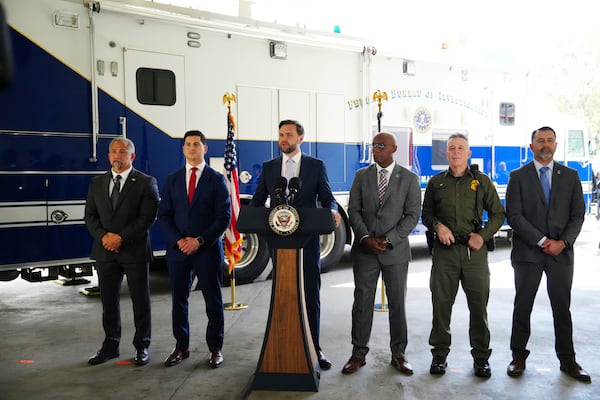 Vice President JD Vance, center, speaks next to officials including, from left to right, HUD Regional Administrator William Spencer, United States Attorney for the Central District of California Bill Essayli, FBI Los Angeles Assistant Director Akil Davis, US Border Patrol Sector Chief Gregory Bovino and ICE Field Office Director Ernie Santacruz at the Wilshire Federal Building Friday, June 20, 2025, in Los Angeles. (AP Photo/Jae C. Hong)